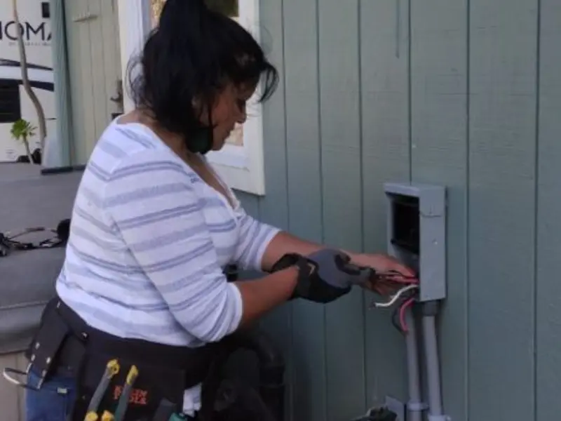 Licensed electrician wiring an exterior subpanel in Lochbuie